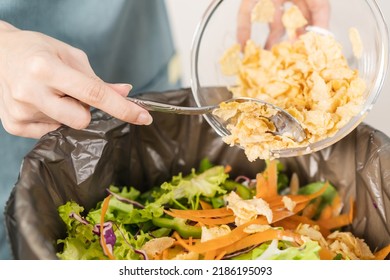 Compost the kitchen waste, recycling, organic meal asian young household woman scraping, throwing food leftovers into the garbage, trash bin from vegetable. Environmentally responsible, ecology. - Shutterstock ID 2186195093