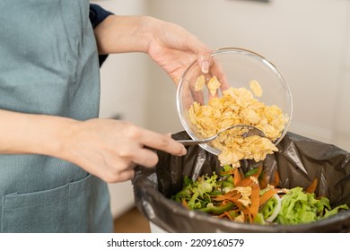 Compost The Kitchen Waste, Recycling, Organic Meal Asian Young Household Woman Scraping, Throwing Food Leftovers Into The Garbage, Trash Bin From Vegetable. Environmentally Responsible, Ecology.