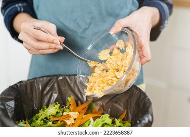 Compost The Kitchen Waste, Recycling, Organic Meal Asian Young Household Woman Use Spoon Scraping, Throwing Food Leftovers Into Garbage, Trash Bin From Vegetable. Environmentally Responsible, Ecology.