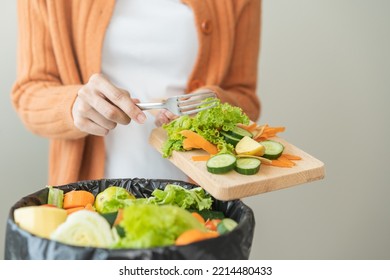 Compost From Leftover Food, Asian Young Housekeeper Woman Hand Holding Cutting Board Use Fork Scraping Waste, Rotten Vegetable Throwing Away Into Garbage, Trash Or Bin. Environmentally Responsible.