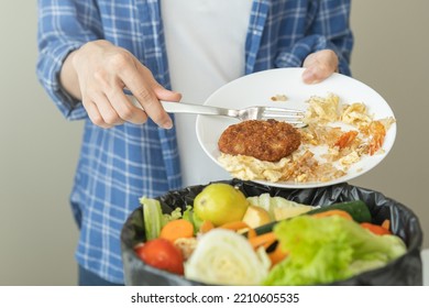 Compost From Leftover Food, Refuse Asian Young Housekeeper Woman, Girl Hand Using Fork Scraping Waste From Dish, Throwing Away Putting Into Garbage, Trash Or Bin.
Environmentally Responsible, Ecology.