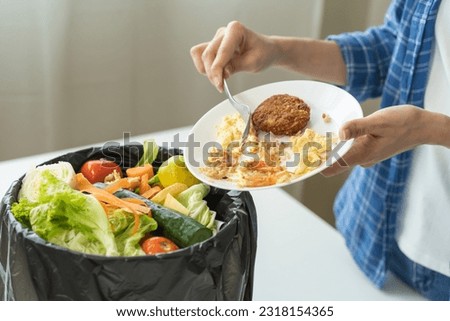 Compost from leftover food, refuse asian young housekeeper woman, girl hand using fork scraping waste from dish, throwing away putting into garbage, trash or bin.
Environmentally responsible, ecology.