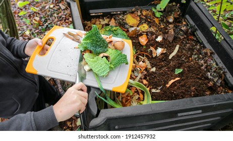 composter with organic waste on the garden - Shutterstock ID 1912457932
