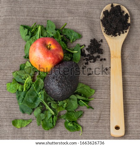 Composting indoors in containers, compost bin with organic material.