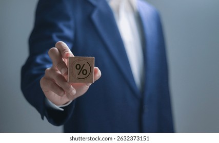 Porcentaje de tasa de interés compuesta sobre inversión, dividendos, fondo de retiro, depósito fijo, Cuenta de ahorros, acciones, fondo mutuo. Hombre de negocios que sostiene el bloque de madera con el icono del porcentaje.