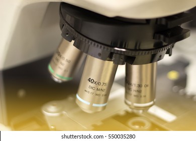 Compound microscope in the Laboratory, close up objective lens with brightness  above stage