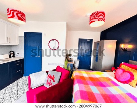 Comprehensive open plan studio apartment layout with micro-kitchen and workspace. 