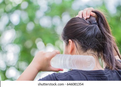 To Compress The Neck With Cold Water Drinking Water After Workout On The Natural Bokeh Background