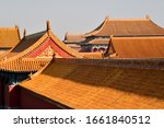 Compressed view of a large number of orange tiled roofs of the ancient palaces of the Forbidden City in Beijing China