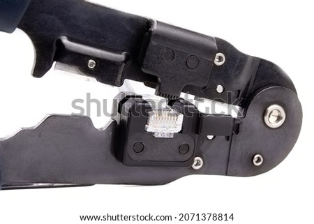 Compression of the Internet connector using a crimper for crimping RJ 45. Internet Network Connector, rj45.Crimping of a unified connector used in telecommunications. Unified connector 8P8C.