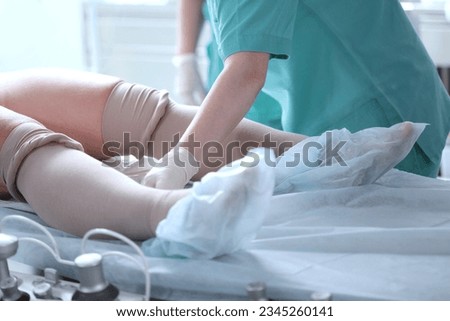 Compression underwear. Before operation, compression underwear is put on patient's legs. Special underwear before surgery. Prevention of varicose veins.
