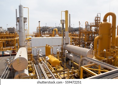 Compressor And Pumping Systems With Many Yellow Pipes And Connections In Oil Field In Azerbaijan Baku. Oil Plant In The Middle Of Caspian Sea. Huge Machinery And Compression Technology.