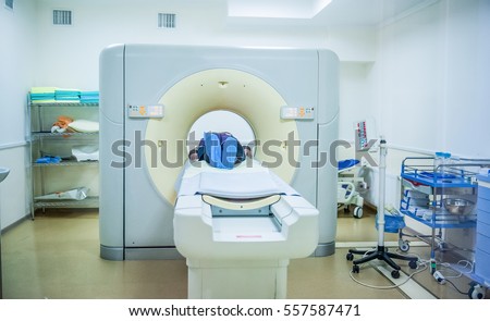 Computed tomography or computed axial tomography scan machine with patient in hospital room