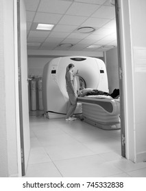 Computed Tomography Scan With Male Patient And Female Doctor. View From Outside Hospital Room.