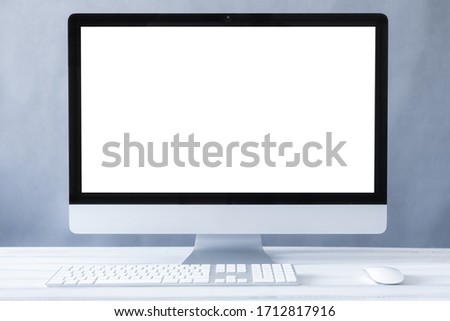 Computer all in one mockup, home and office workspace concept. Computer white blank screen on work table front view. Copy space