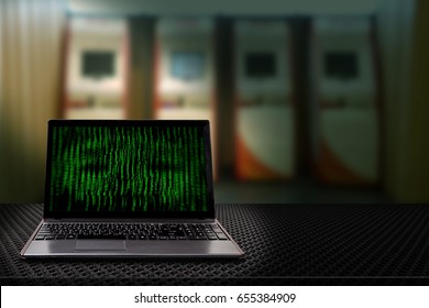 Computer with binary codes from monitor with Automatic Teller Machine blur background