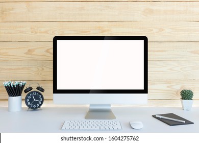 Computer with blank white copy space for text and wood background, Mockup design desktop computer in office on white table with keyboard and Coffee cub, Cactus in pot, Black alarm clock.  - Shutterstock ID 1604275762