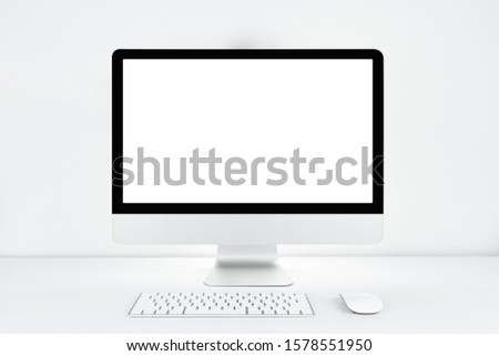Computer with blank white copy space for text, Mockup design desktop computer in office on white table with keyboard and Coffee cub, Work place concept, Cactus in pot.