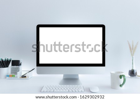 Computer with blank white copy space for text, Mockup design desktop computer in office on white table with keyboard and Coffee cub, Work place concept.