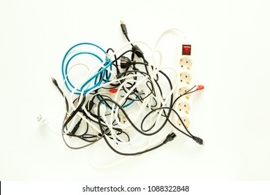 Computer Cables, Electronic Wires, Extension And Chargers In A Messy Heap. Home Electronic Chaos Concept, Flat Lay, View From Above