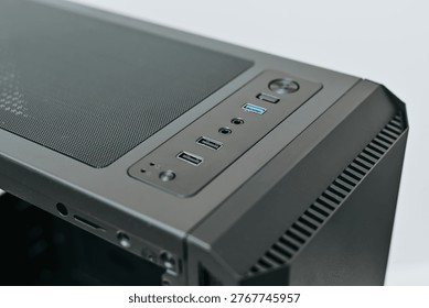 A computer case sits on a flat surface, showcasing various ports for connectivity. The design allows for easy access to USB connections and audio inputs for users working on a custom PC.