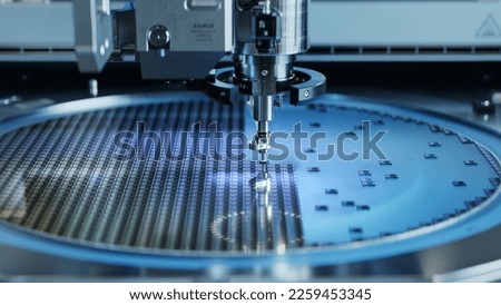 Computer Chip Manufacturing. Semiconductor Wafer after Dicing Process. Silicon Dies are Being Extracted by Pick and Place Machine. Packaging Process.