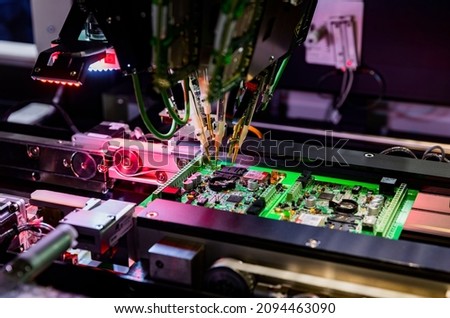 Computer circuit board assembly and flying test probe. Selective focus.