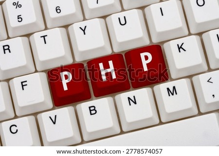 Computer coding with php, A close-up of a keyboard with red highlighted text PHP