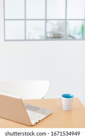 Computer and coffee on table