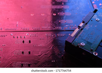 Computer cpu processor chip on circuit board ,motherboard background. Close-up. With red-blue lighting.