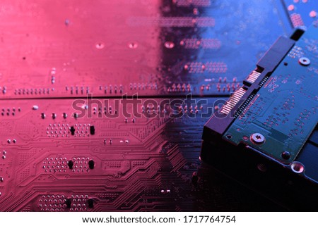 Computer cpu processor chip on circuit board ,motherboard background. Close-up. With red-blue lighting.