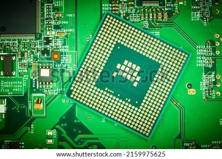 Computer cpu processor chip on circuit board with motherboard background. Close-up.