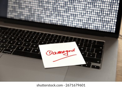 Computer damaged, note on the keyboard of a laptop. Warning, defect, malfunction, error,  interruption, binary code, failure, noise, break down, computer bug, interference, device screen.