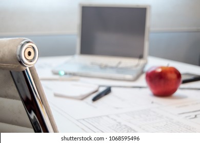 computer desk, glasses, note pad and an apple