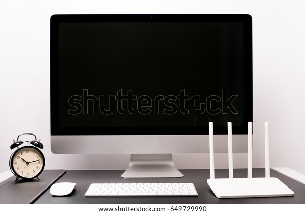 computer desktop technology concept\
retina display with keyboard mouse alarm clock and\
router