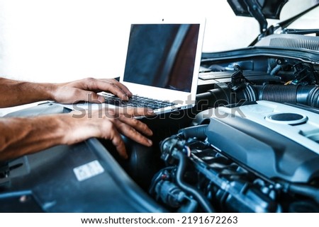 computer diagnostics of car engine concept photo. car electrician doing car diagnostics.  car engine chip tuning
