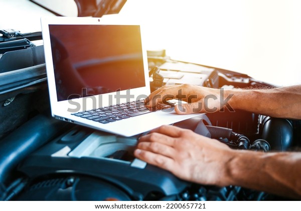 computer diagnostics\
of car engine concept photo. car electrician doing car diagnostics.\
 car engine chip\
tuning