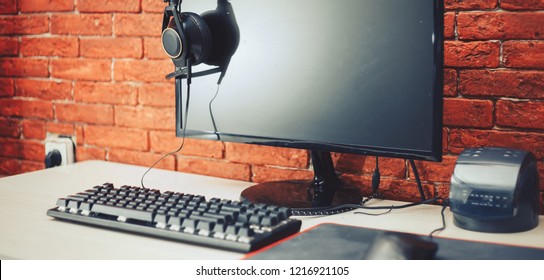 Computer Display And Gaming Tools On Desk. Desktop Computer Screen Is Black. Modern Creative Workspace Background. Front View.