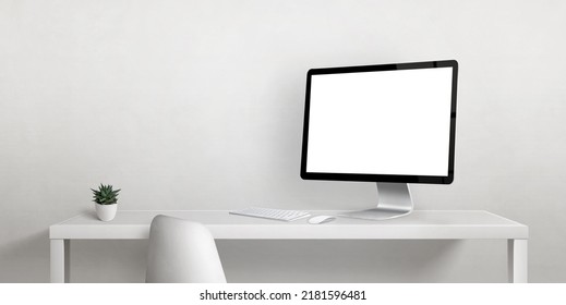 Computer Display Mockup On Work Desk With Copy Space Beside On White Wall. Isolated Display Screen For Web Page Promotion