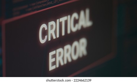 Computer displaying critical error message flashing on screen after cyber crime attack and hacking alert. Monitor display showing computer malfunction and error threat, system crash. Close up.
