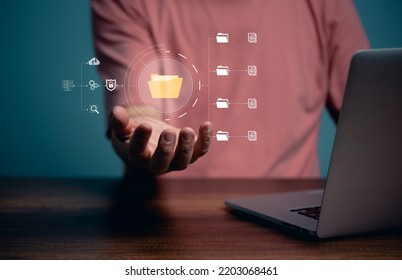 Computer Document management system concept, business man holding folder, files, document, database and cyber safety icon software for efficient archiving and company safety data protection.
