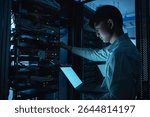 Computer engineer is setting up network in server room,Systems Maintenance Technician,Male engineer working in server room at modern data center