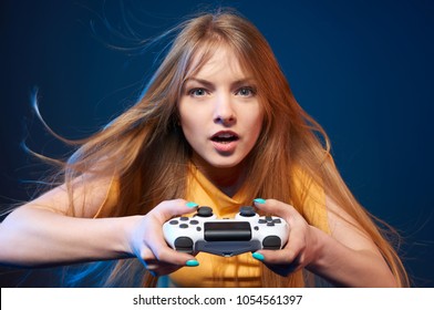 Computer game competition. Gaming concept. Excited girl playing video game with joystick