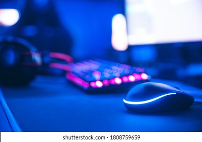 Computer Gamer Workplace For New Game Mouse And Keyboard With Blur Pink Neon Light Background.