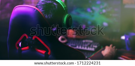 computer games, playing place, young gamer plays computer games with headphones,