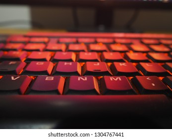 Computer Gaming Keyboard Illuminated RGB Red/Orange lights for technology background
