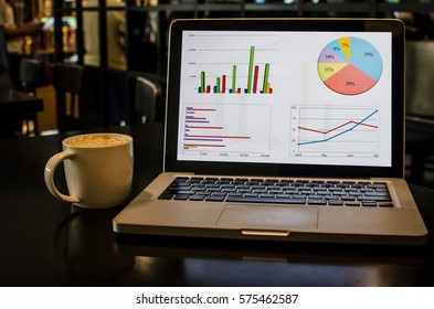 Computer and graph and coffee cup on the table - Filter vintage