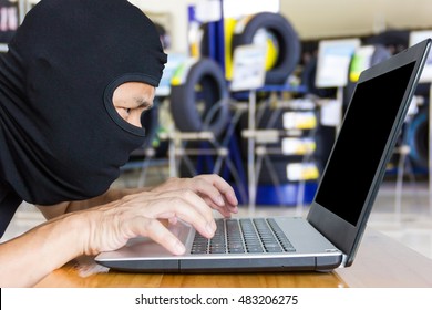 Computer Hacker, Blur Image Of Inside The Tire Shop As Background.