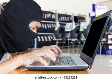 Computer Hacker, Blur Image Of Inside The Tire Shop As Background.