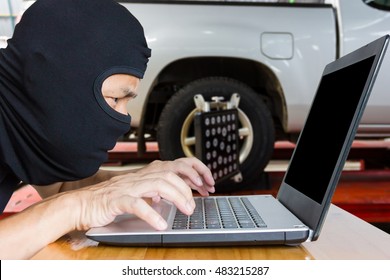 Computer Hacker, Blur Image Of Inside The Tire Shop As Background.